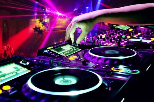 A party hall image showing DJ equipment and one hand operating it.